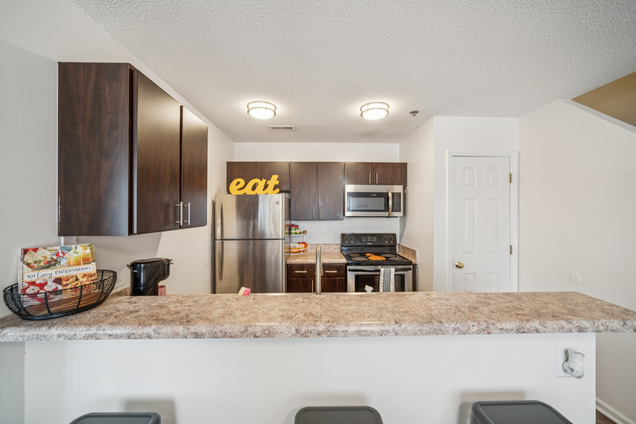 a kitchen with a granite counter top and a refrigerator