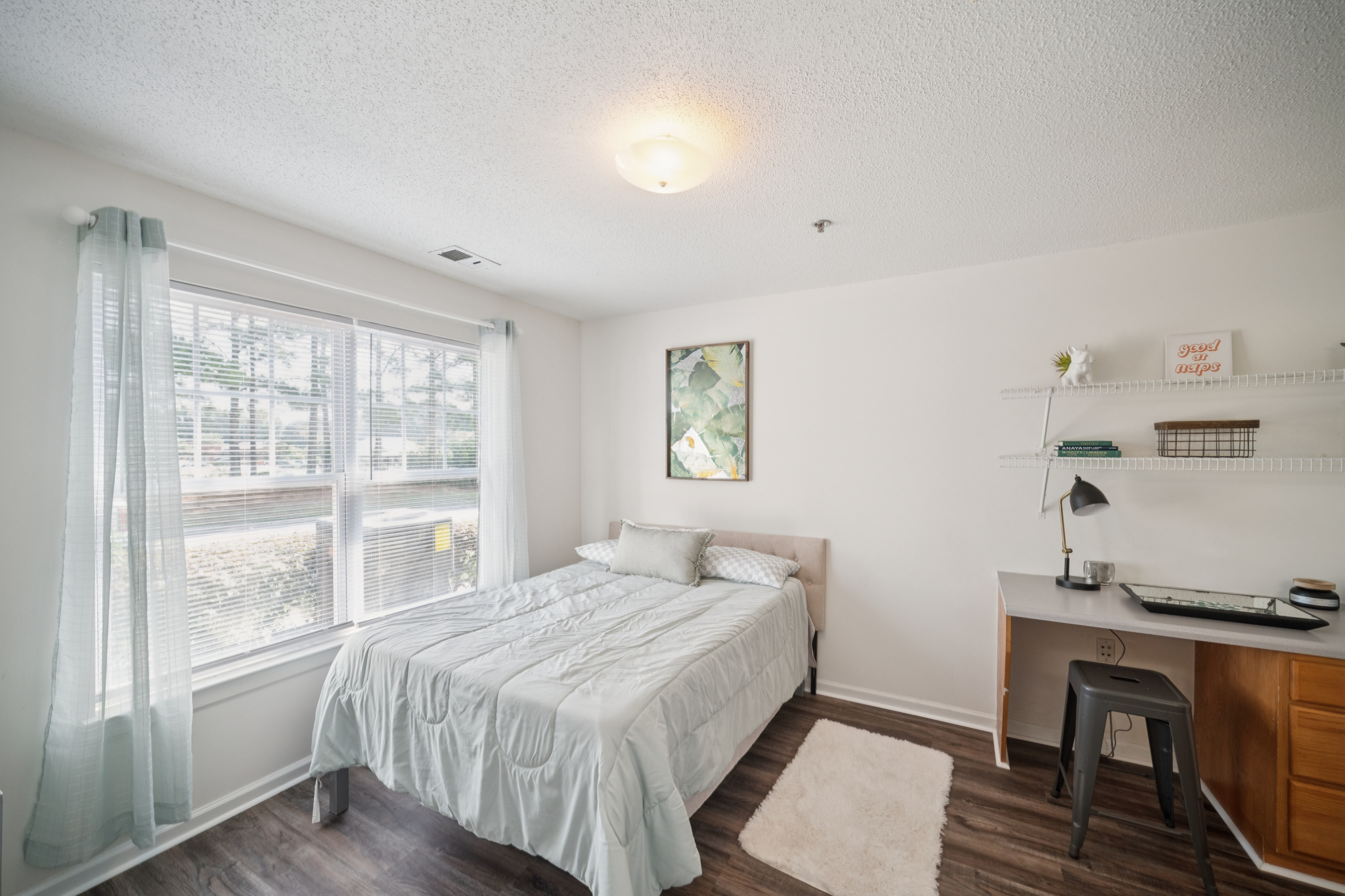 a bedroom with a bed and a desk