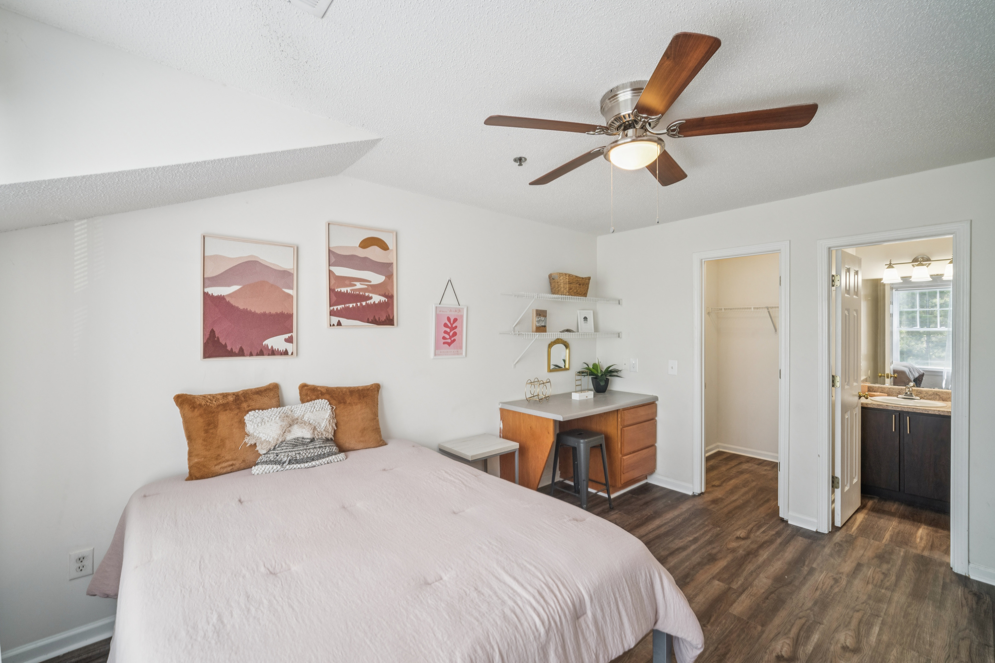 a bedroom with a ceiling fan and a bed
