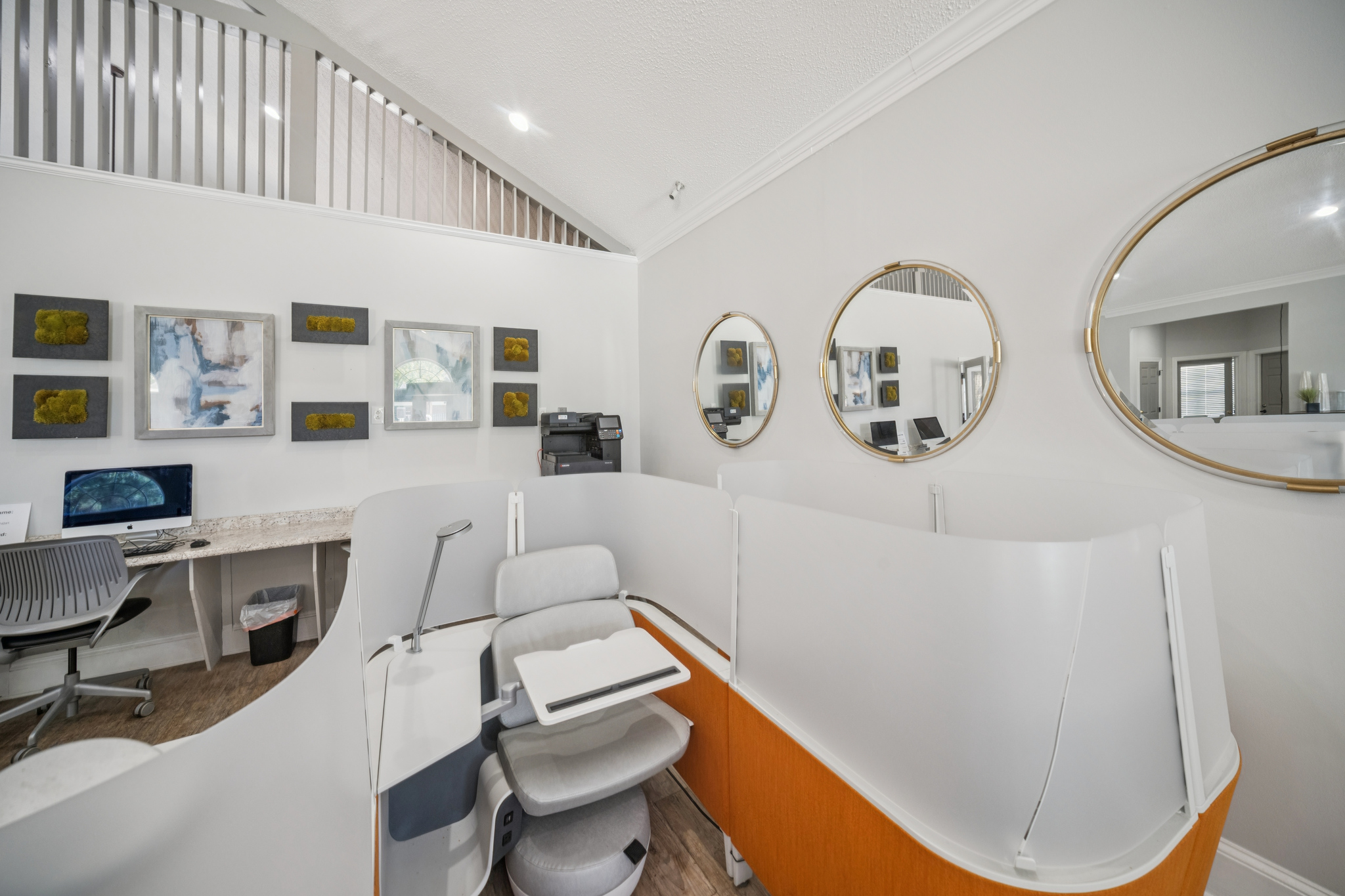 a room with a chair and mirrors