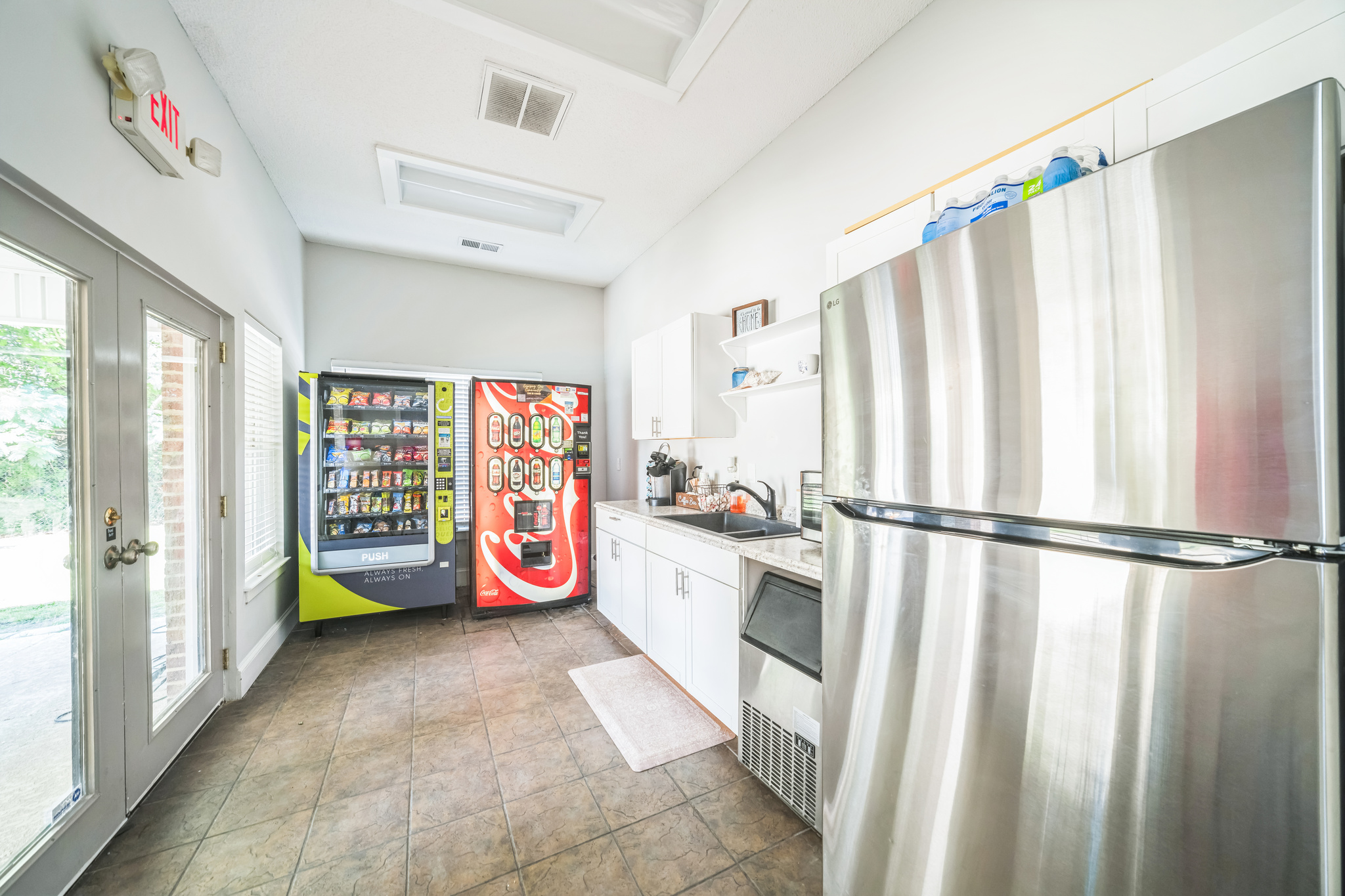 a kitchen with a refrigerator and a vending machine