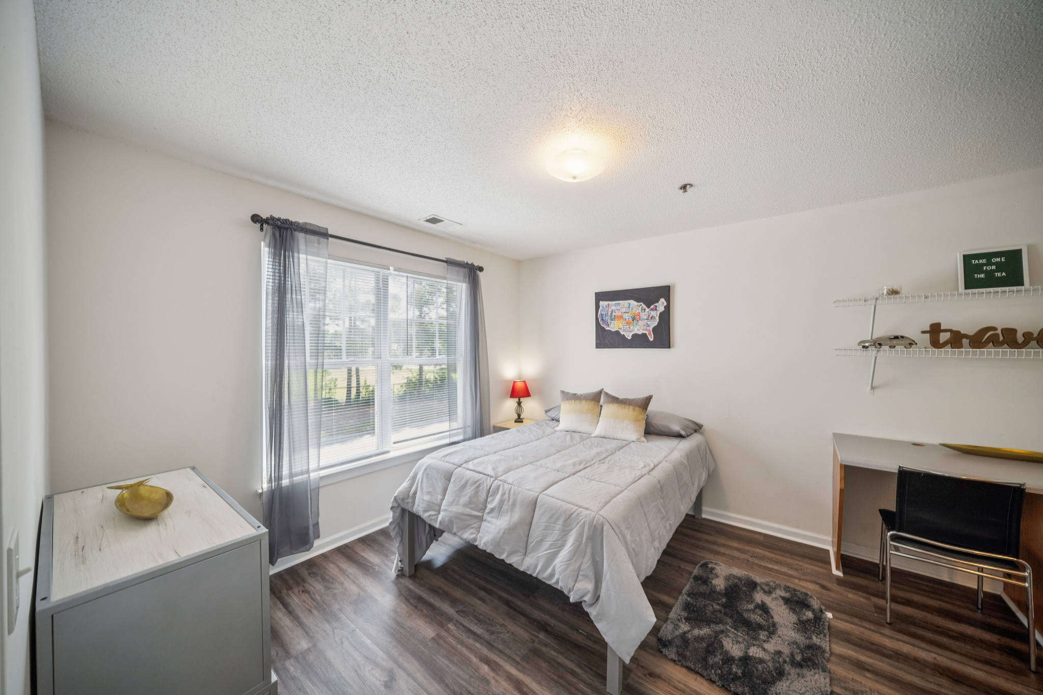 a bedroom with a bed and a lamp