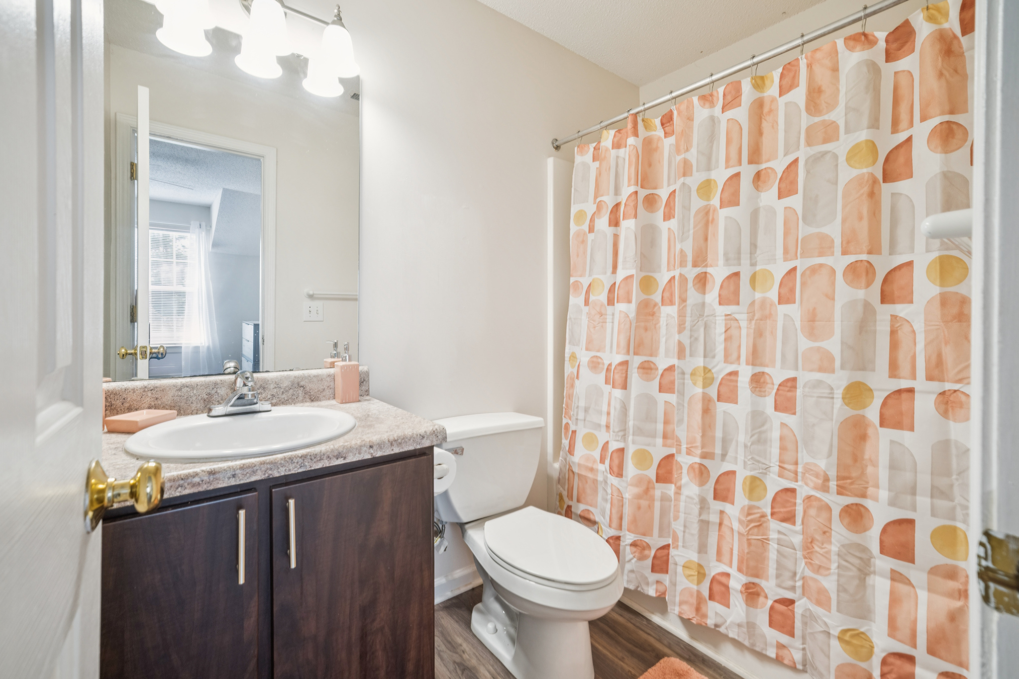 a bathroom with a shower curtain and sink