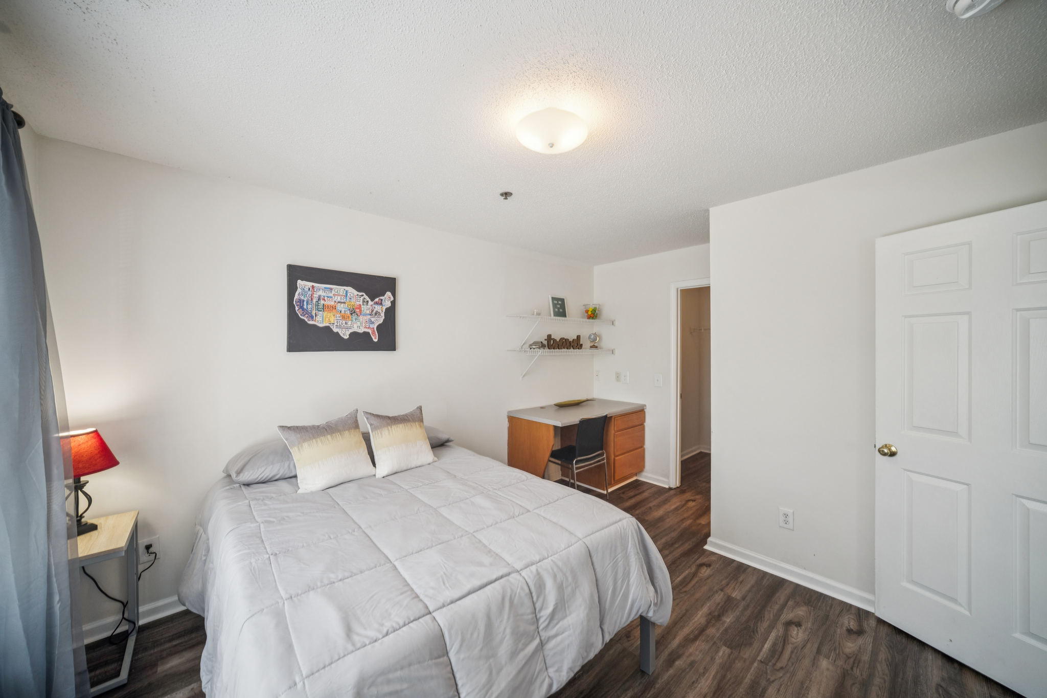 a bedroom with a bed and desk