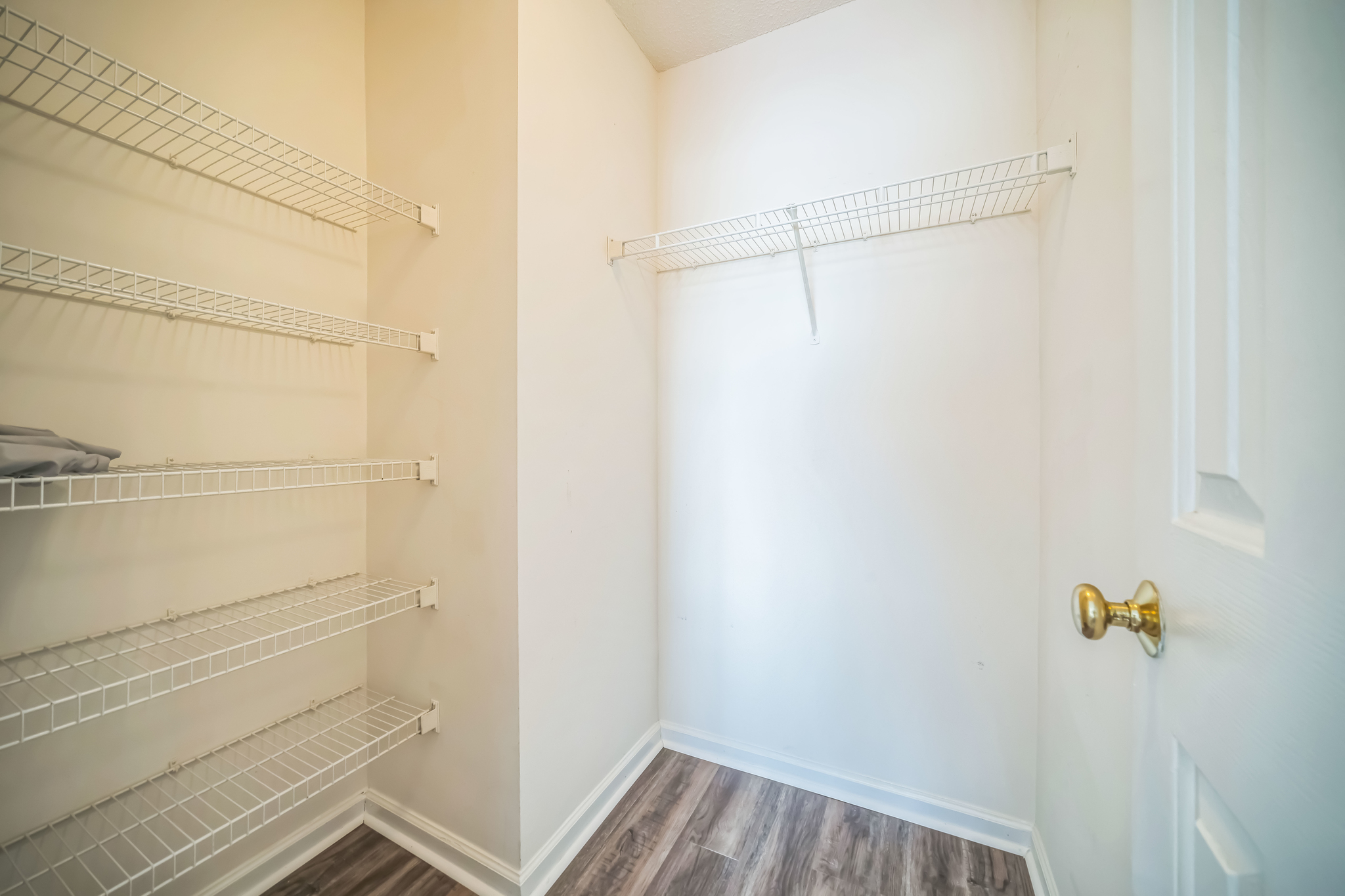 a empty closet with shelves and a door