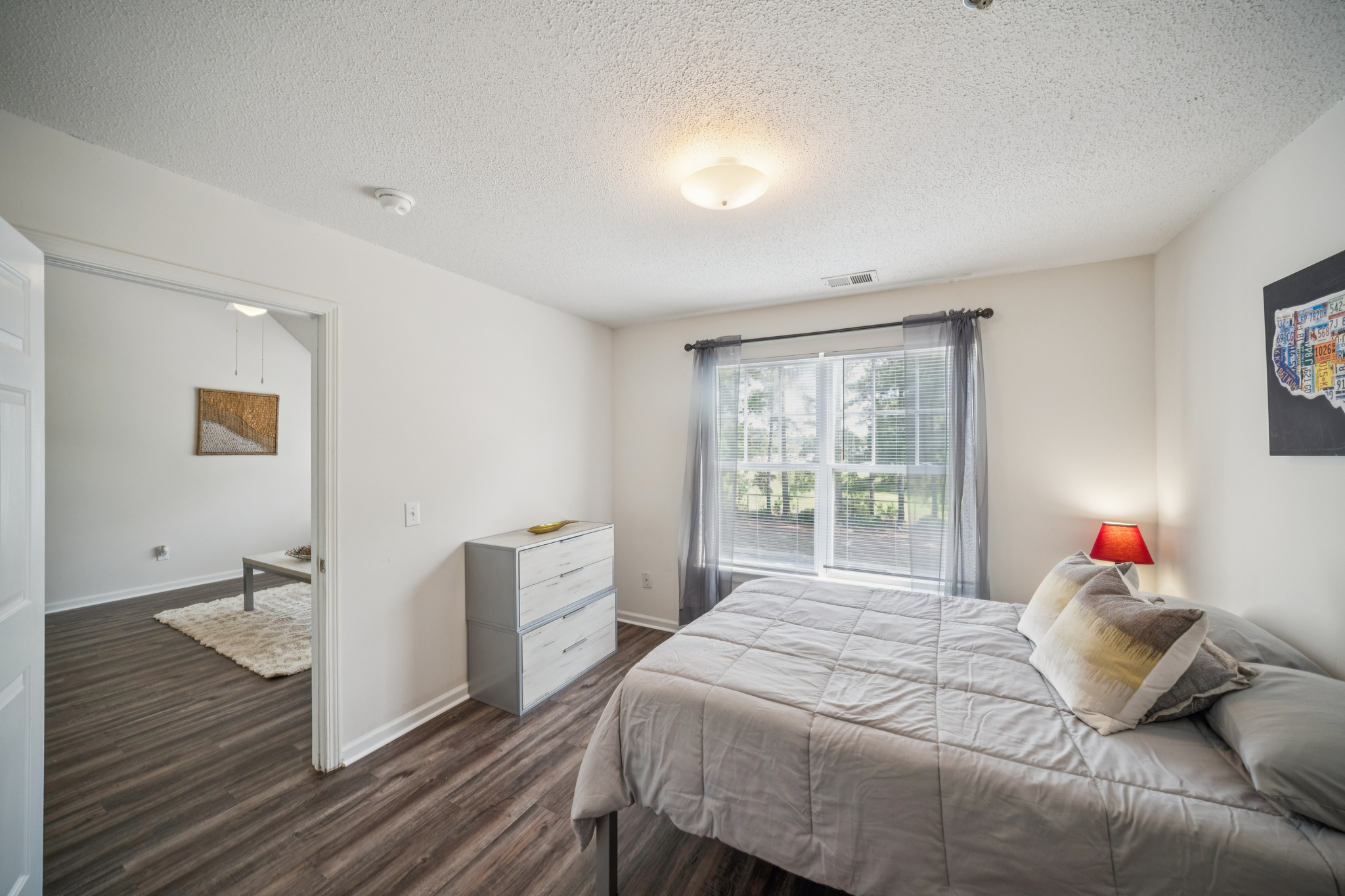 a bedroom with a bed and a wood floor