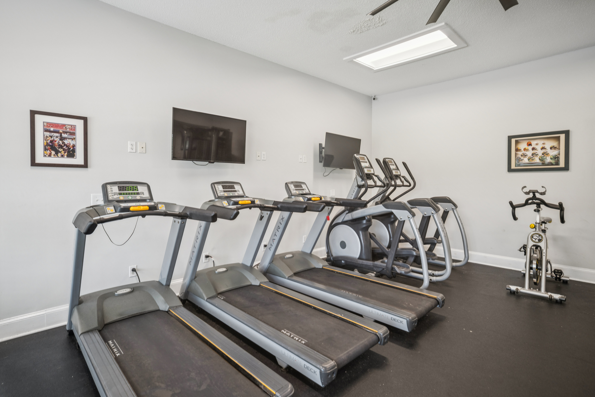 a room with treadmills and a tv